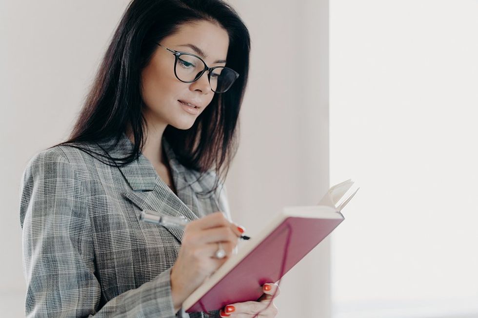 Professional woman writes down her goals