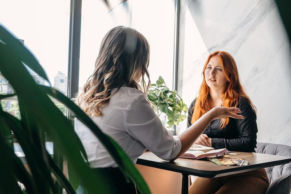 Professional women networking and talking over their lunch break