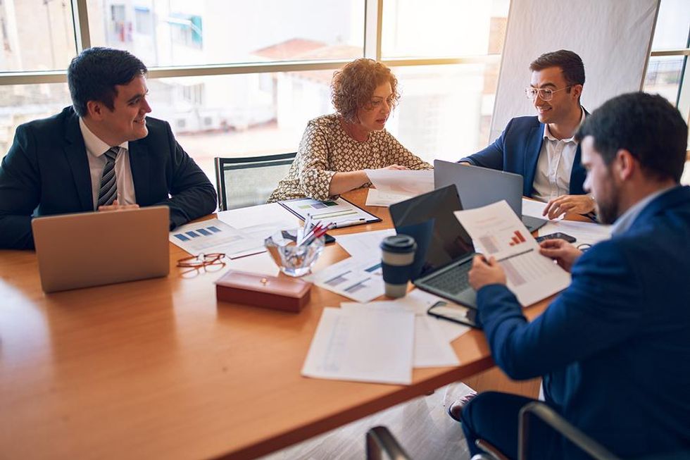 Professionals in a meeting exhibit good business etiquette