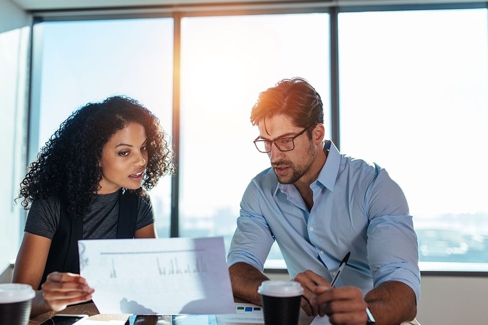 Professionals talk about their personal brands during a work meeting