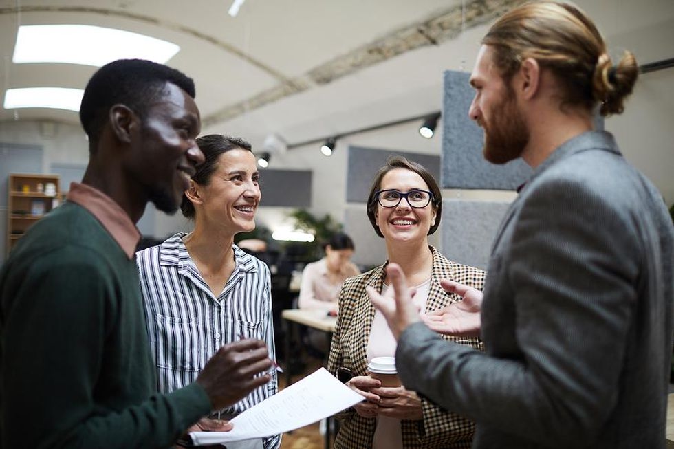 Professionals talk and work on a project together