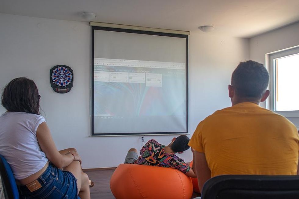 Professionals watch a PowerPoint presentation at work