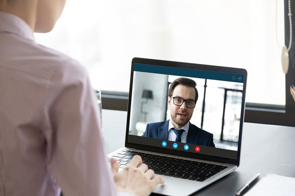 Professionals with good business etiquette attend a Zoom meeting