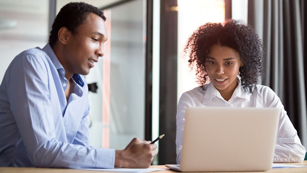 Project manager explains something to a co-worker