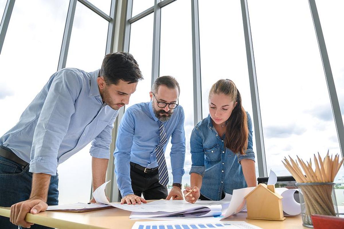 Project managers discuss a project execution plan