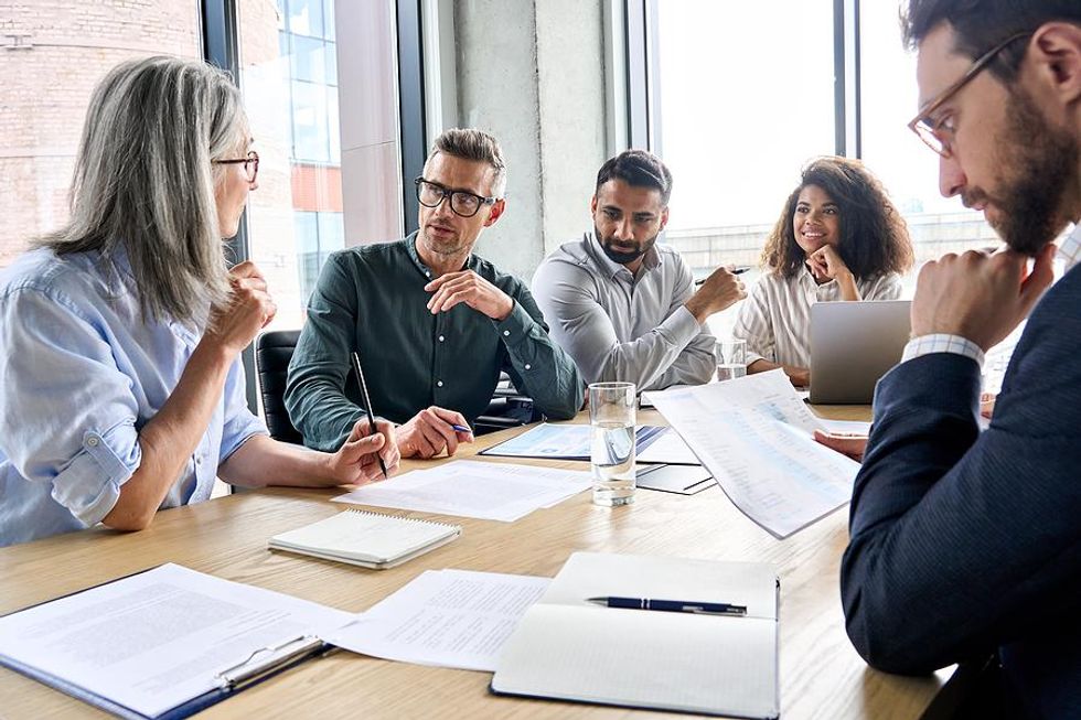 Project managers discuss a project in a meeting