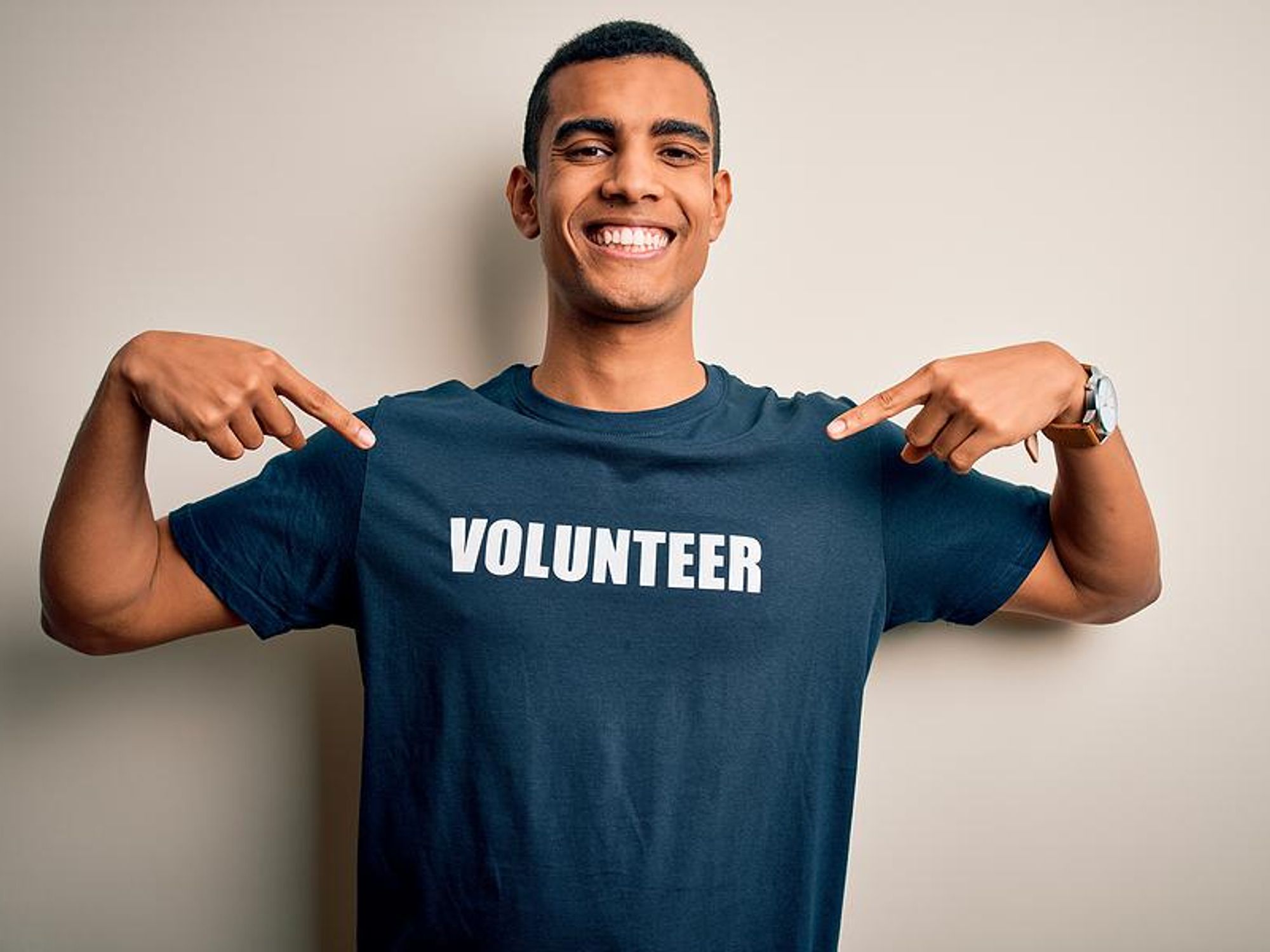 Proud volunteer points to his shirt