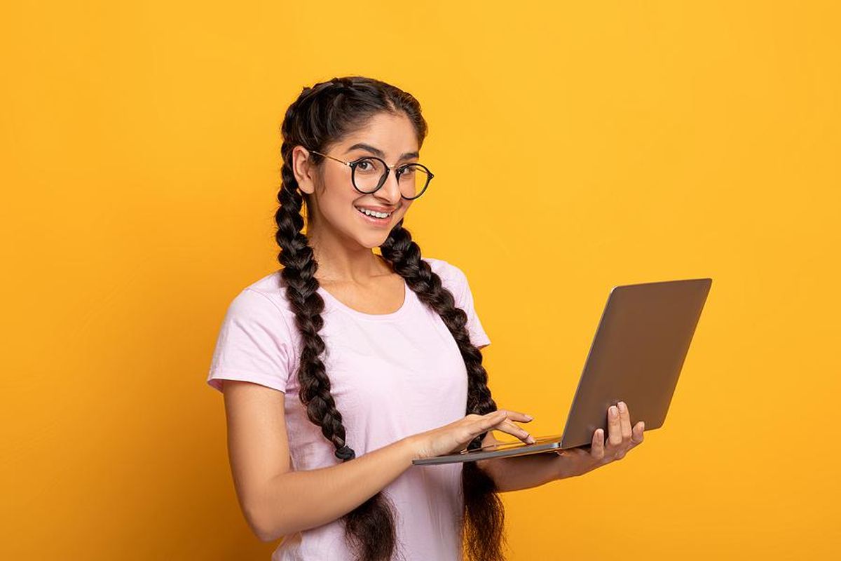 Recent college grad holding work laptop