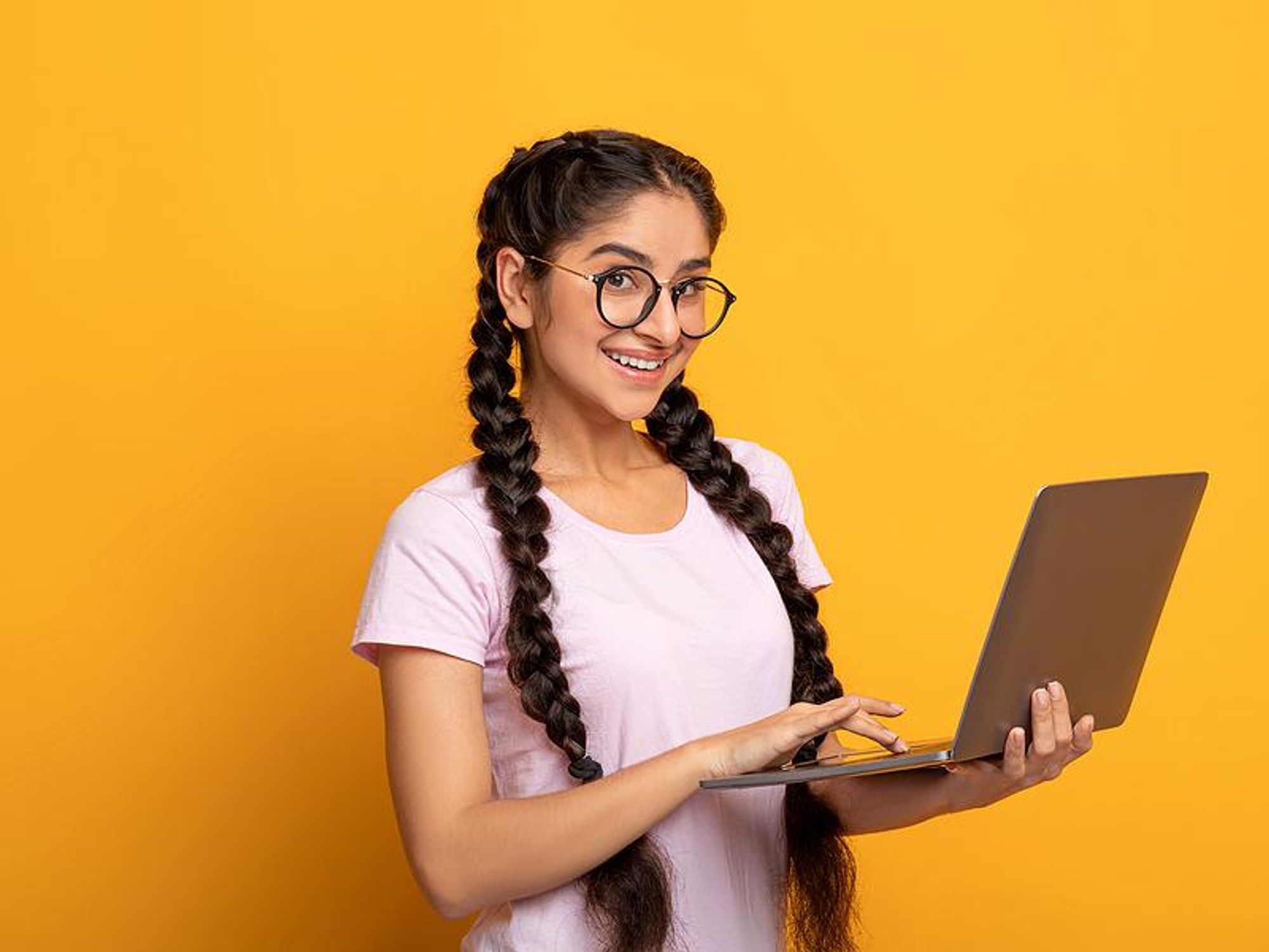 Recent college grad holding work laptop