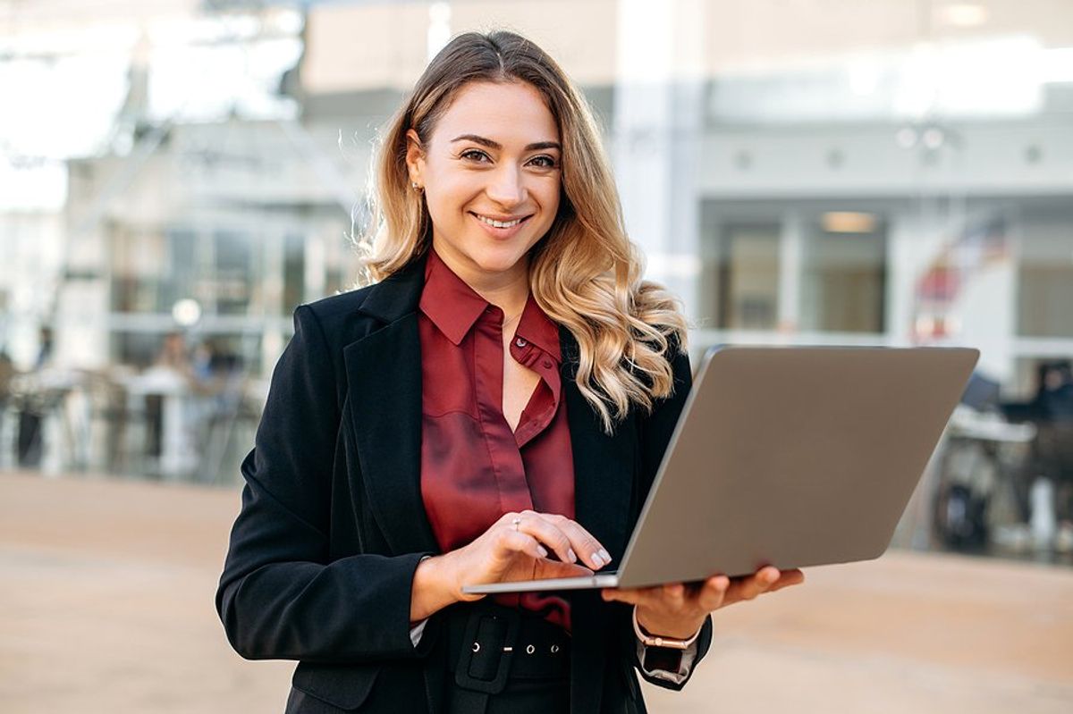 Recruiter / hiring manager holding laptop creates a job description