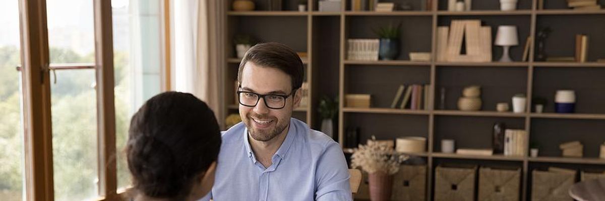 Recruiter holds a job candidate's resume and cover letter during an interview