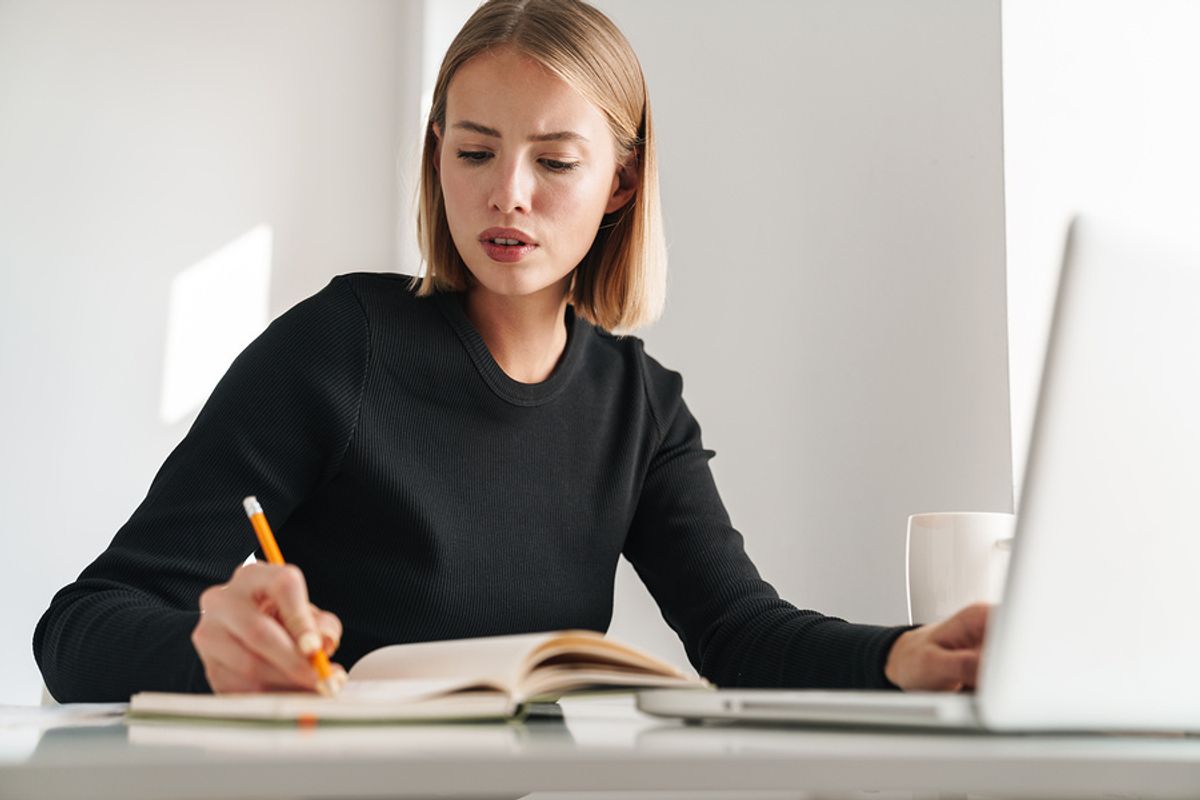 Recruiter looking at a possible job candidate's social media writes something down