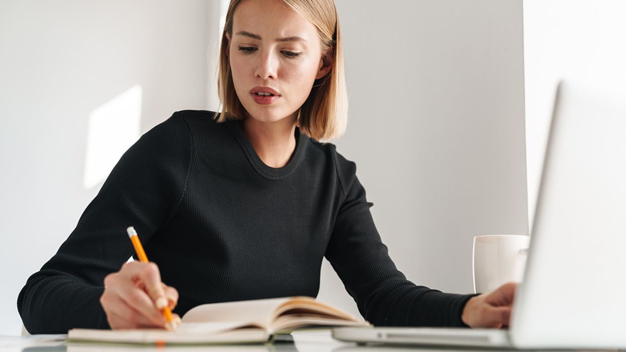 Recruiter looking at a possible job candidate's social media writes something down