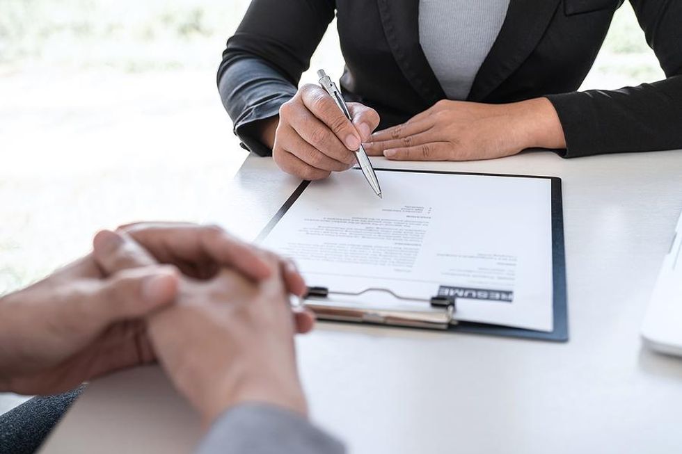 Recruiter looks over a job candidate's resume