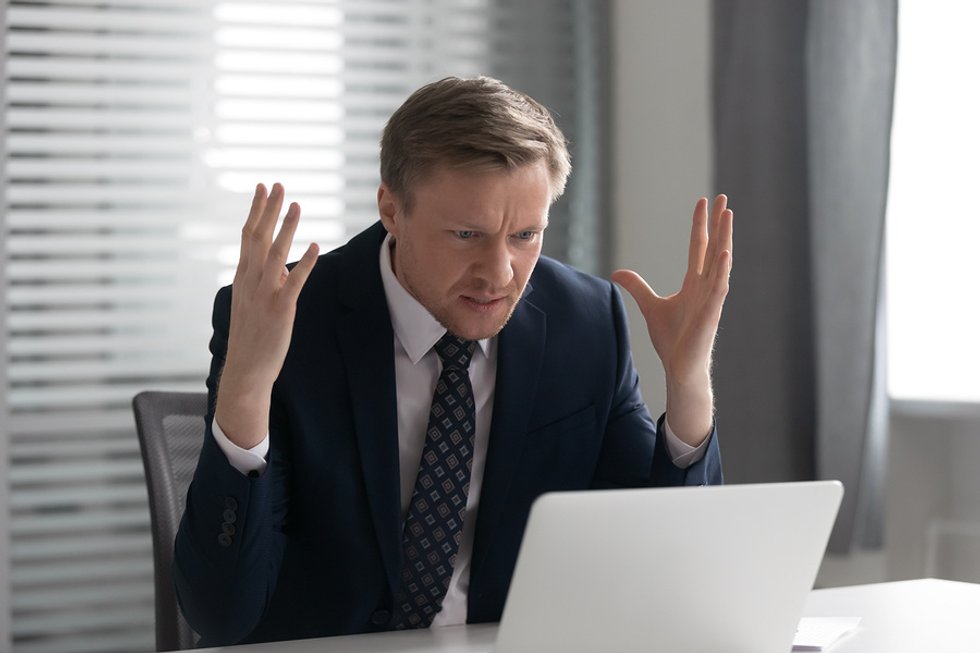 Recruiter on laptop feeling frustrated after reading common cover letter mistakes