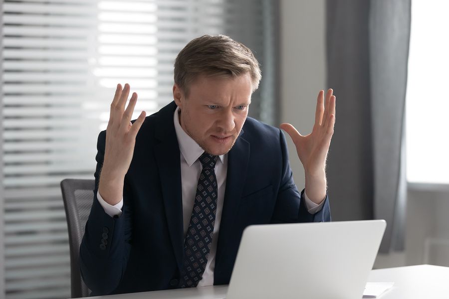 Recruiter on laptop feeling frustrated after reading common cover letter mistakes