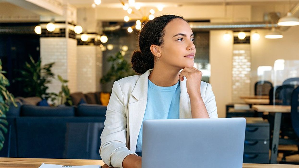 Recruiter on laptop thinks about how she can fill a role in an unfamiliar industry