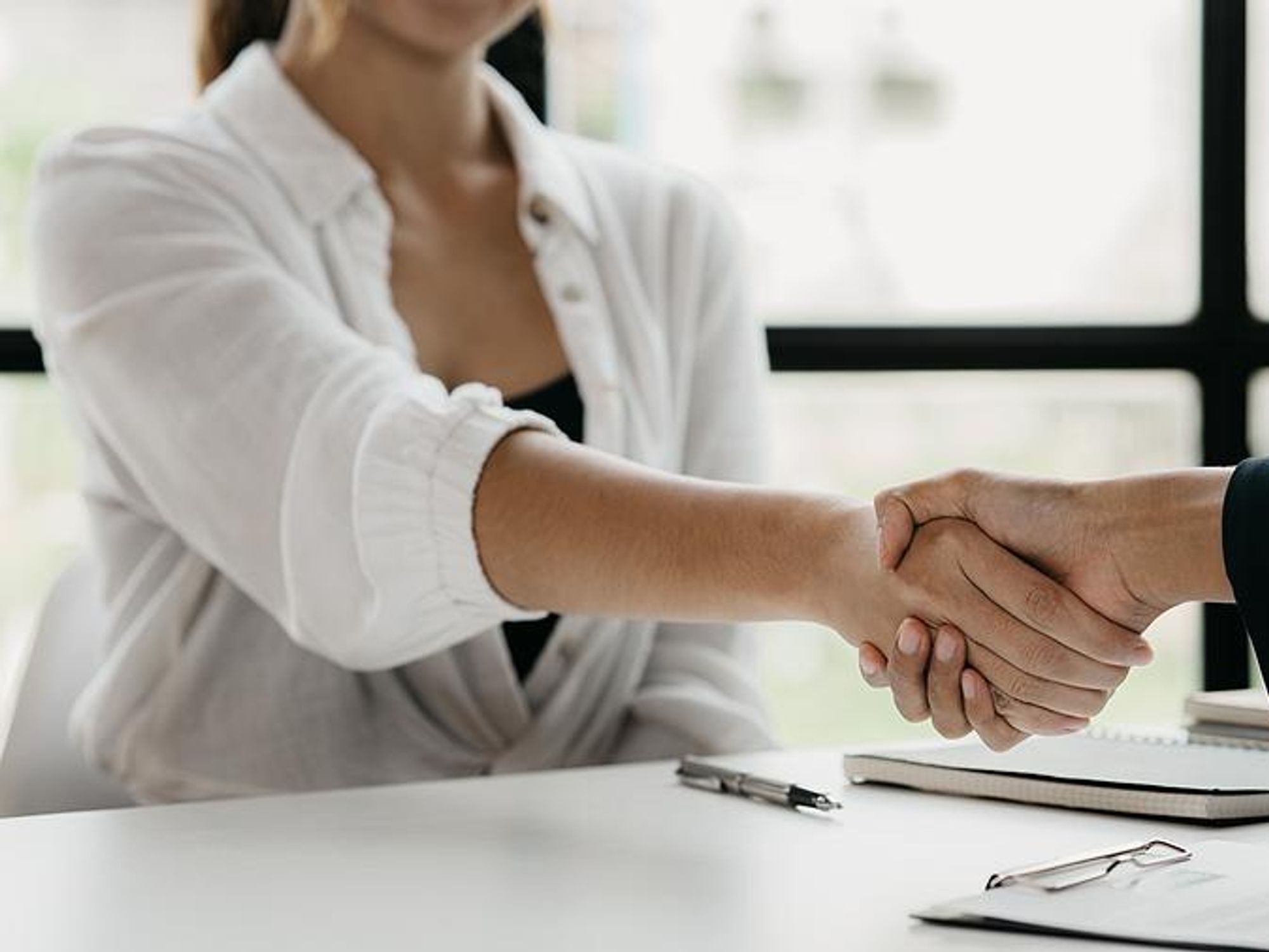 Recruiter shakes hands with a job candidate