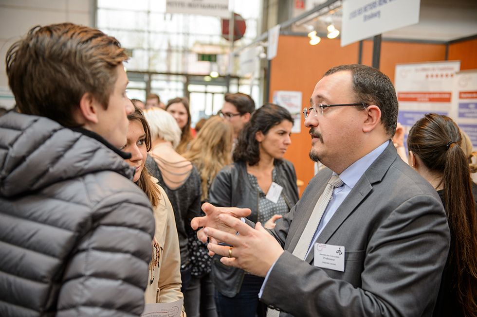 Recruiter talks to job seekers at a job fair