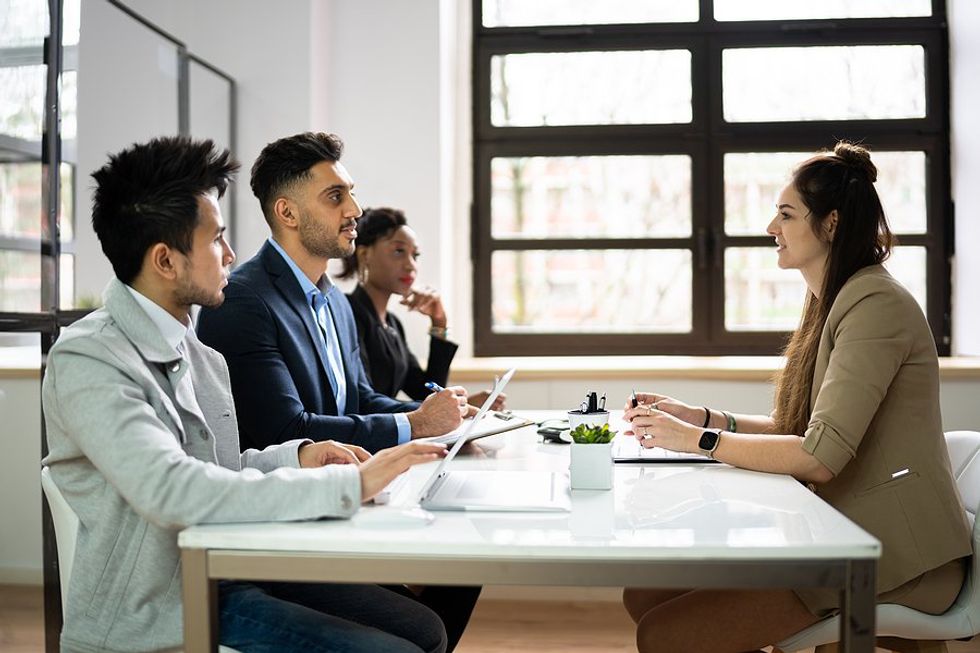 Recruiters / hiring managers talk to a job candidate during an interview