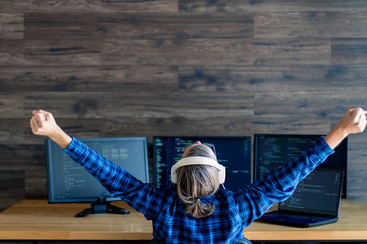 Remote worker stretches while in her home office.