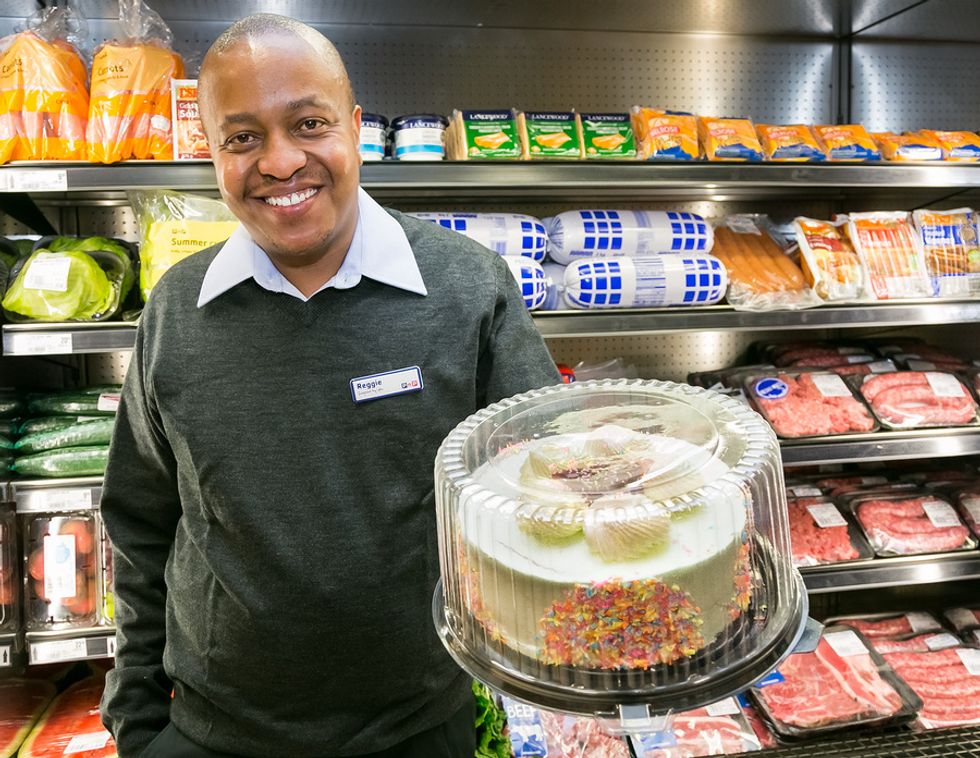 Retail manager holds an item from his grocery store