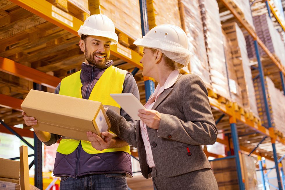 Retail manager talks with a retail worker on the job