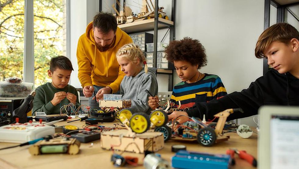 Robotics teacher helps his students