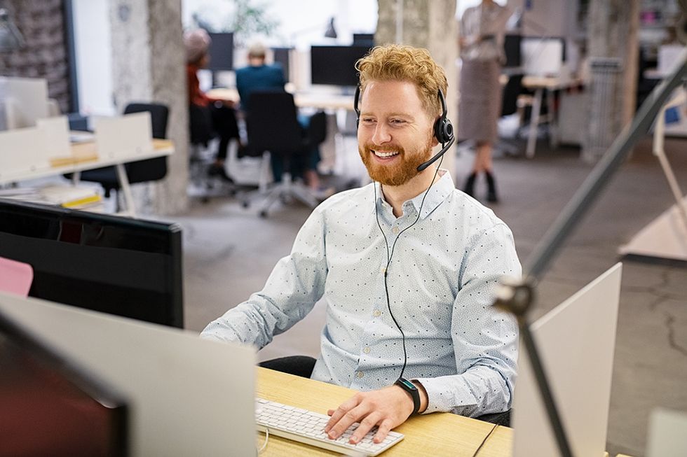 Salesperson listens to a call to help a customer