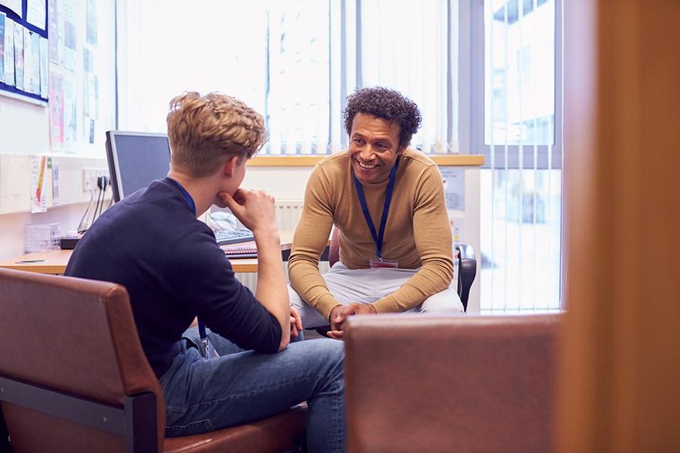 School counselor, teacher talks to a student