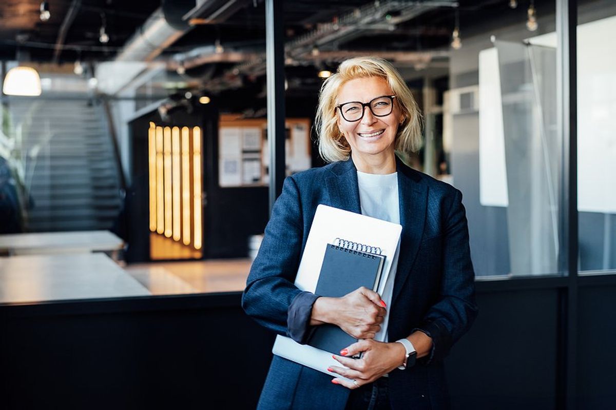 Seasoned professionals smiles while talking about career development