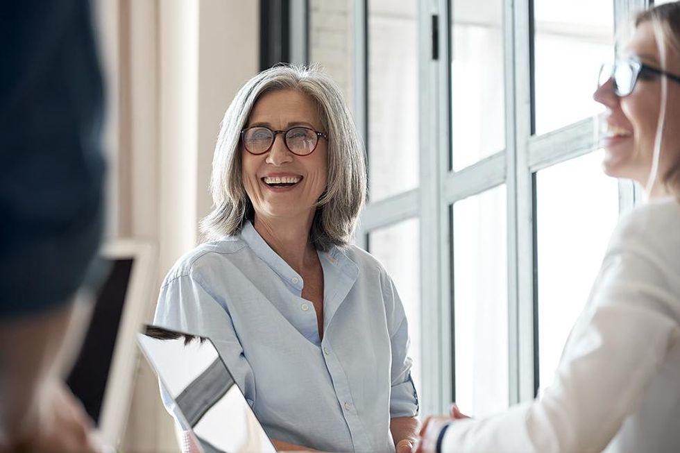 Senior manager talks to a colleague
