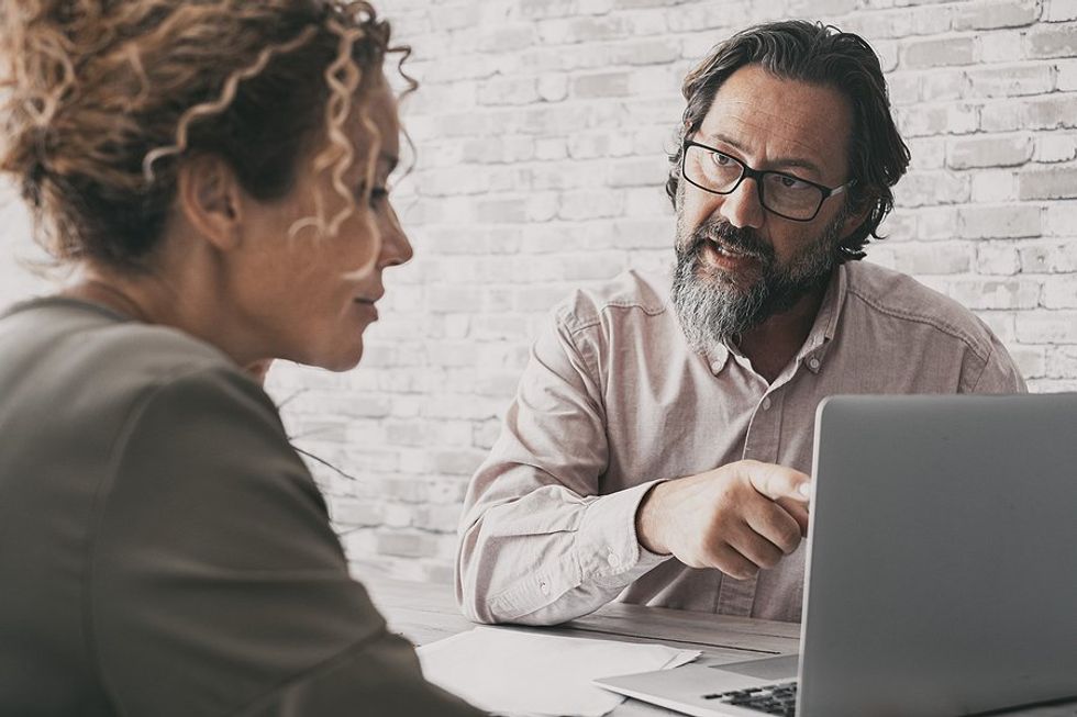 Serious man talks to a customer/client during a meeting