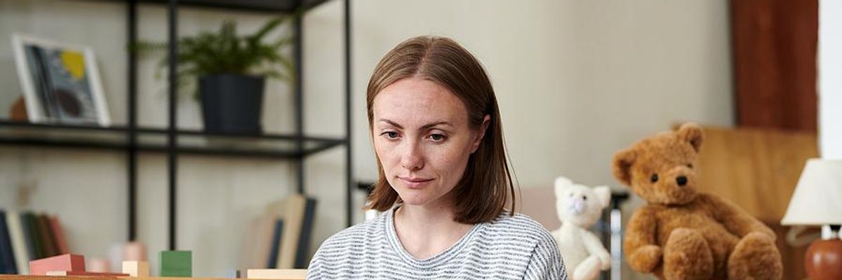 Serious woman looks for a job on her laptop