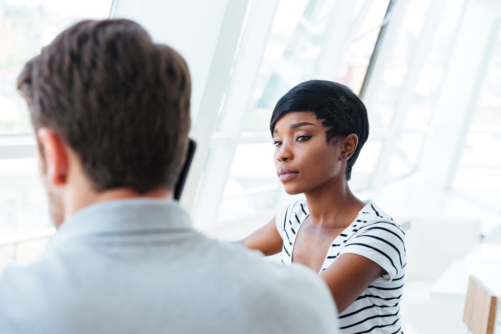 Serious woman tells her boss she's leaving her job