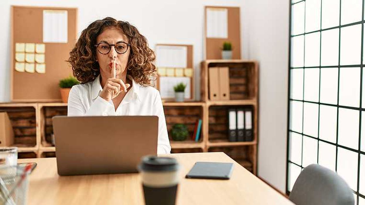 Silent executive on laptop at her desk