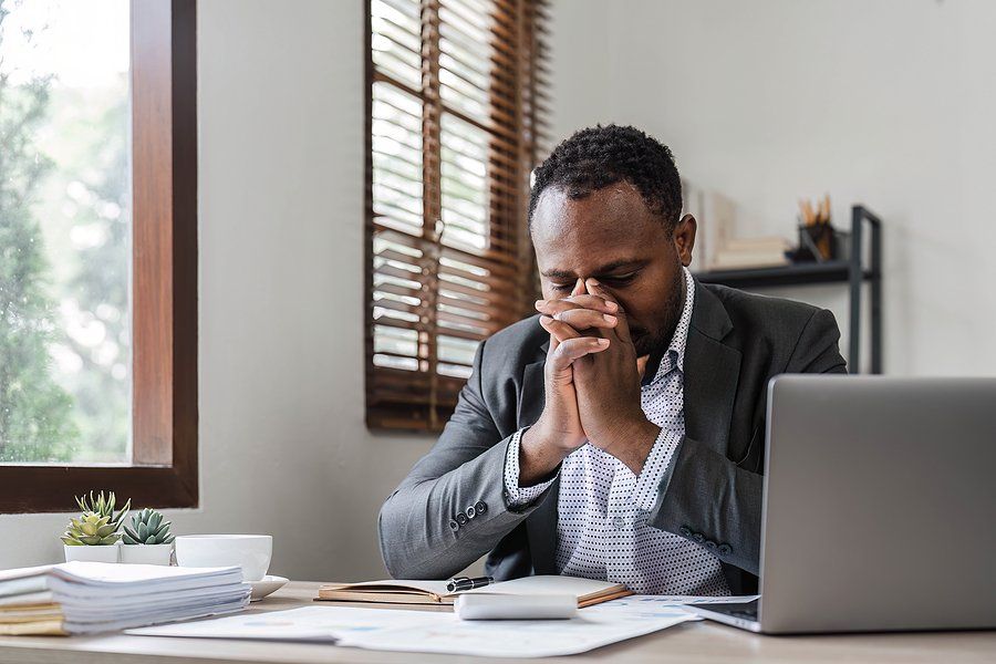 Stressed man on laptop can't find a job