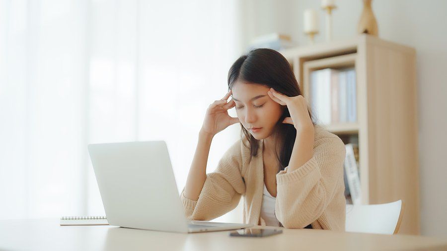 Stressed woman on laptop in a career rut