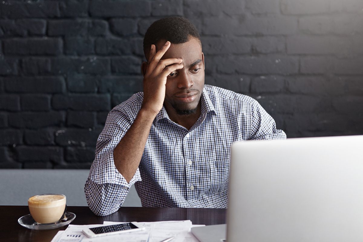 Stressed young professional on laptop shows frustration after being rejected from a job