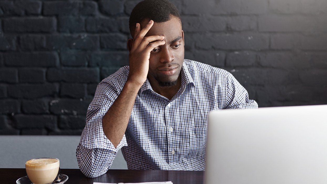 Stressed young professional on laptop shows frustration after being rejected from a job