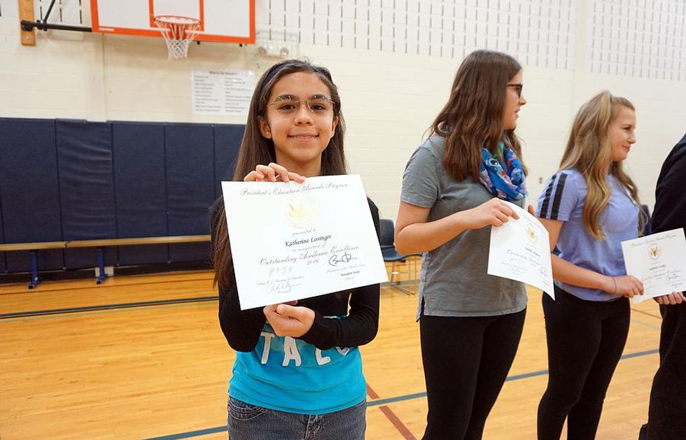 Student receives an award at school