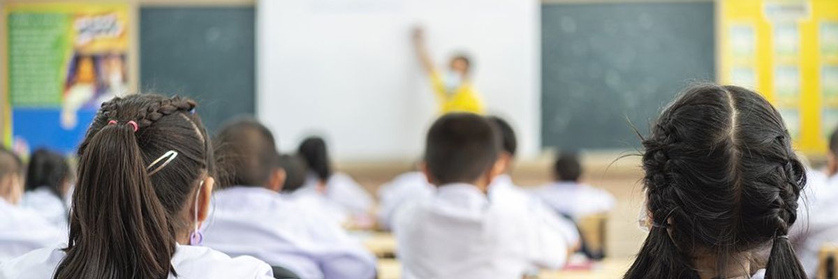 Students listen to their teacher in the classroom