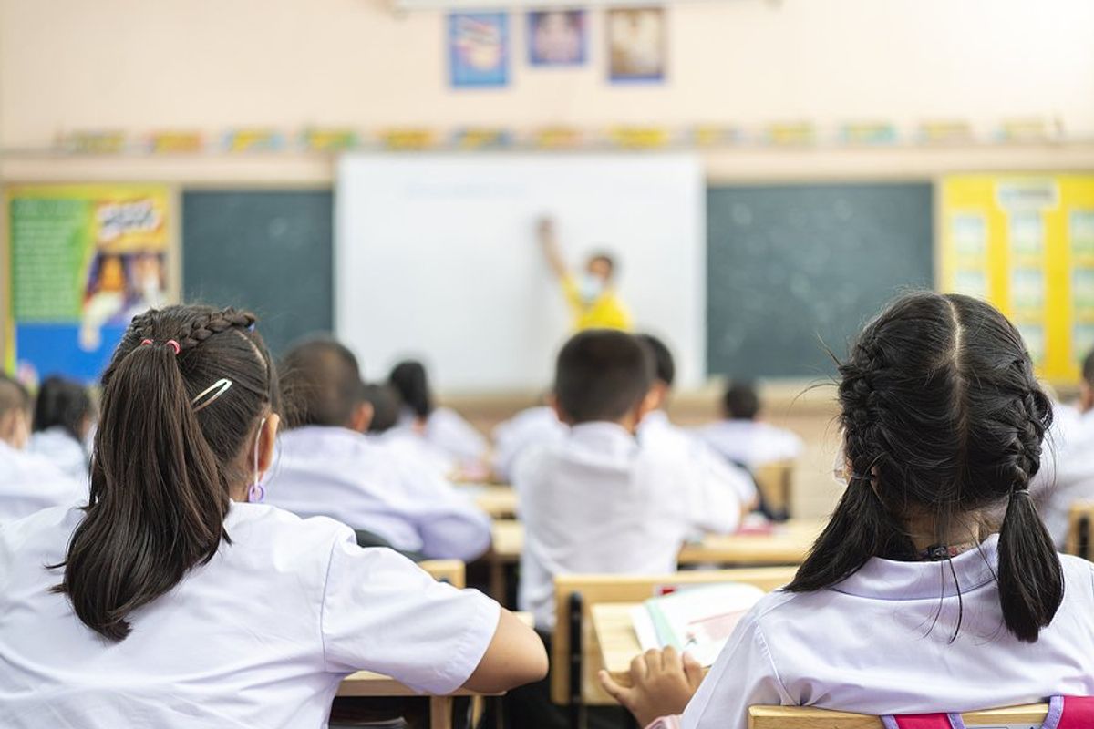 Students listen to their teacher in the classroom