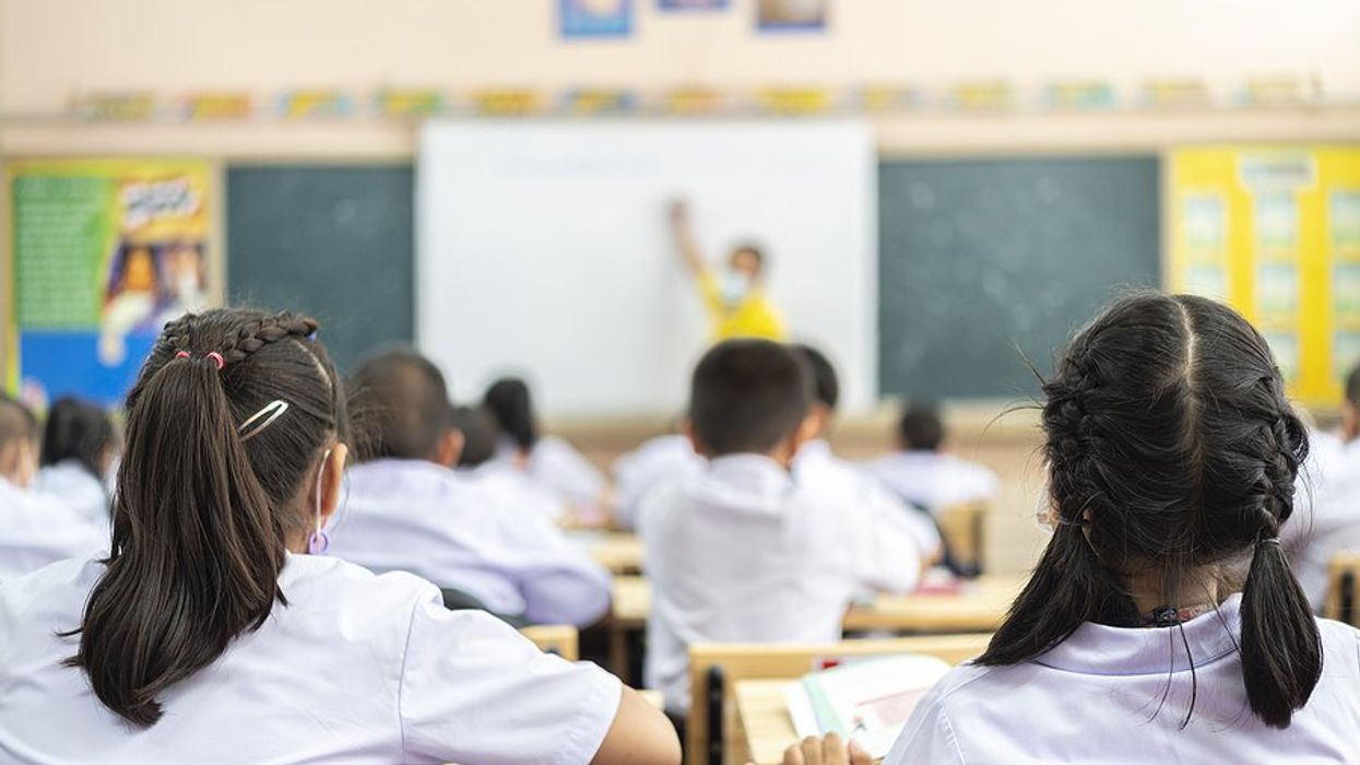 Students listen to their teacher in the classroom