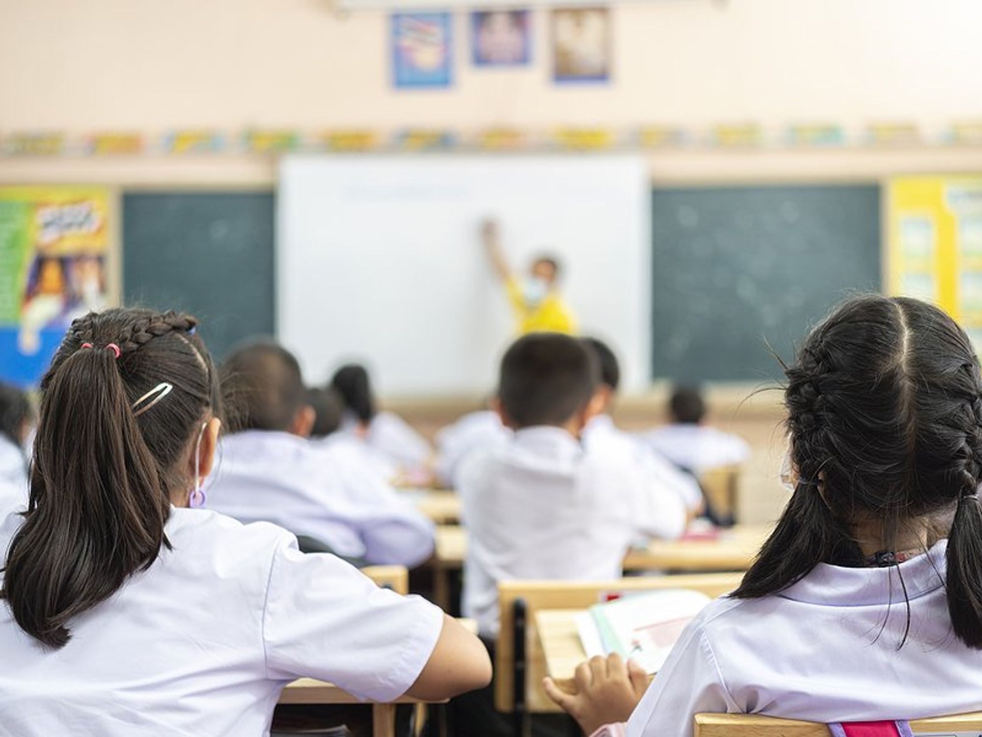 Students listen to their teacher in the classroom