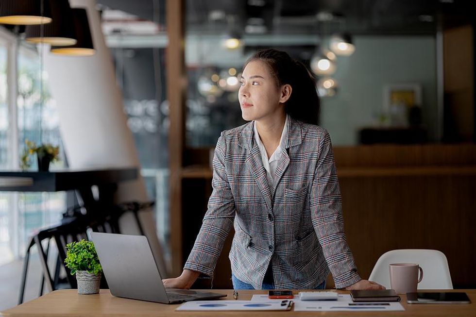 Successful woman working in her office at work