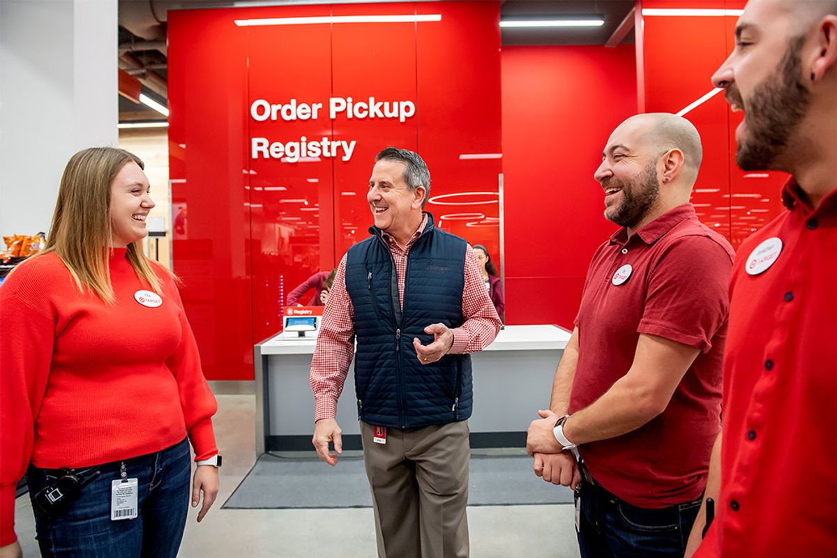 Target CEO Brian Cornell speaks with employees at a Target store.