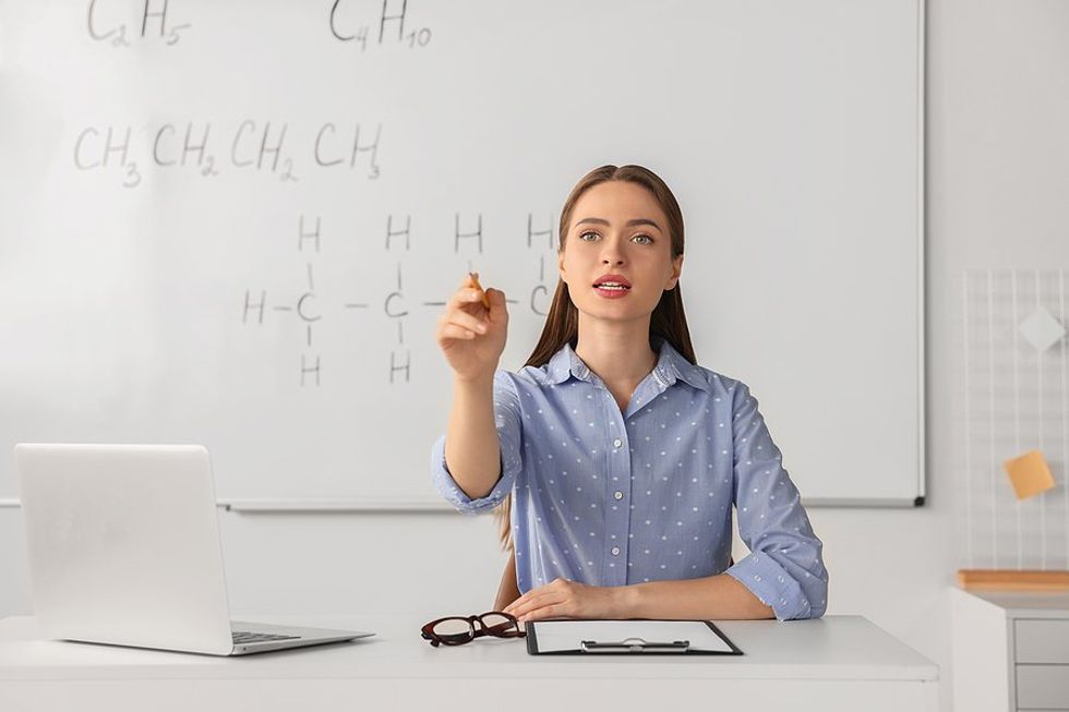 Teacher asks questions while being observed by an administrator