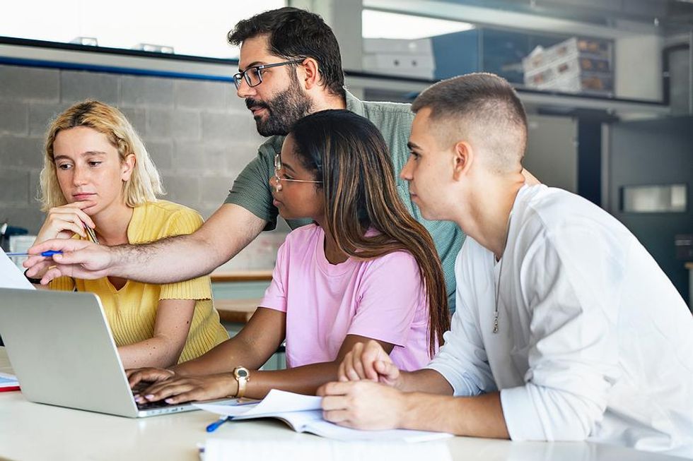 Teacher educates his students on a new concept