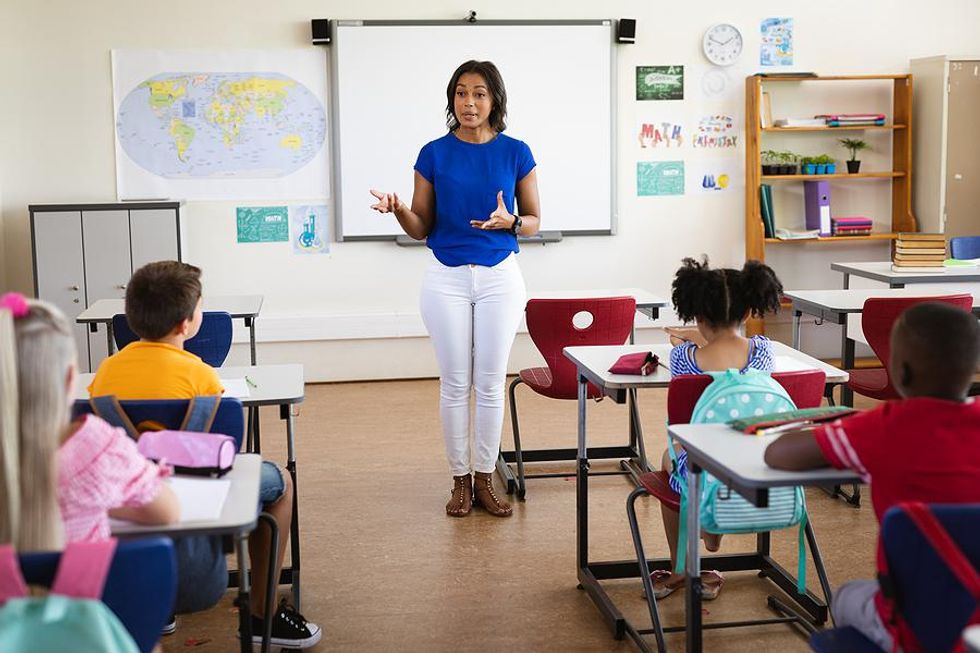 Teacher explains something to her students